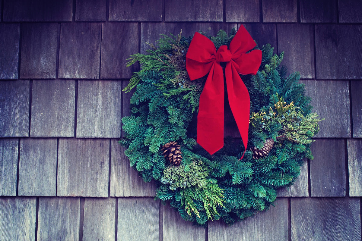 Holiday door wreath installed as part of a Christmas lighting display